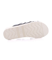 The image displays the bottom view of the Bed|Stü Abraham Light sandal, featuring a black upper and a white, textured, non-slip sole with a lightweight outsole, set against a white background.