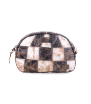 The Abundance pouch by Bed|Stü is a small zippered accessory crafted from reclaimed leather in a black, brown, and white checkered patchwork design for a sustainable touch, shown against a white background.