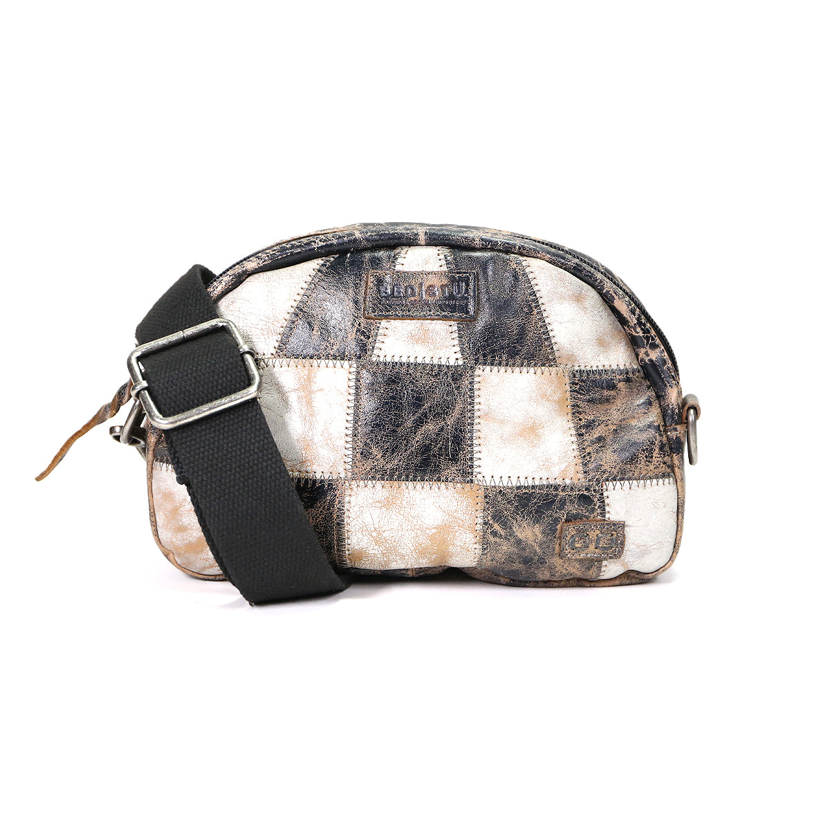 The Bed|Stü Abundance is a small crossbody bag with a black adjustable strap, showcasing a unique and sustainable patchwork design crafted from distressed black, brown, and white reclaimed leather squares.