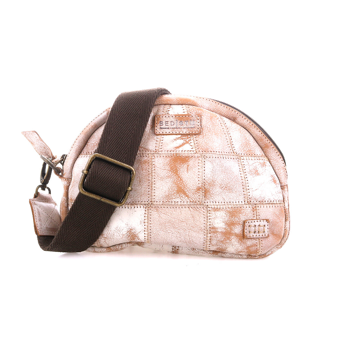 The Abundance by Bed|Stü is a small, sustainable fabric crossbody bag with a light brown and white patchwork pattern, featuring a dark brown adjustable strap crafted from reclaimed leather and finished with a zipper closure.