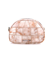 Introducing Abundance by Bed|Stü: a small tan and white patchwork pouch crafted from sustainable reclaimed leather, featuring a zipper closure, curved top, and a metal Bed|Stü label on the front. This compact crossbody bag is photographed against a plain white background.