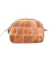 The Abundance pouch by Bed|Stü is a light brown patchwork zippered accessory, expertly crafted from reclaimed leather with visible stitching and a small rectangular logo on the front, embodying sustainable style.