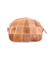 Introducing Abundance, a patchwork tan leather cosmetic bag with a zipper, crafted from sustainable reclaimed leather and featuring the Bed|Stü logo plaque on the front, shown against a white background.