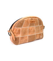 Abundance, a tan leather zippered pouch by Bed|Stü, showcases a patchwork pattern crafted from reclaimed leather and features a small embossed logo on the front, displayed against a white background.