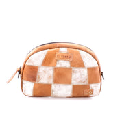 The Abundance pouch by Bed|Stü is a small, zippered accessory handcrafted from reclaimed leather in a brown and white patchwork design for a sustainable touch. Featuring "Bed|Stü" and "DO" logos on the front, it can also be styled as a compact crossbody bag.