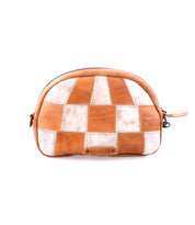 Abundance by Bed|Stü is a brown and white patchwork crossbody bag made from sustainable, reclaimed leather, showcasing a rounded top, zipper closure, and a small branded label on the front, photographed against a white background.