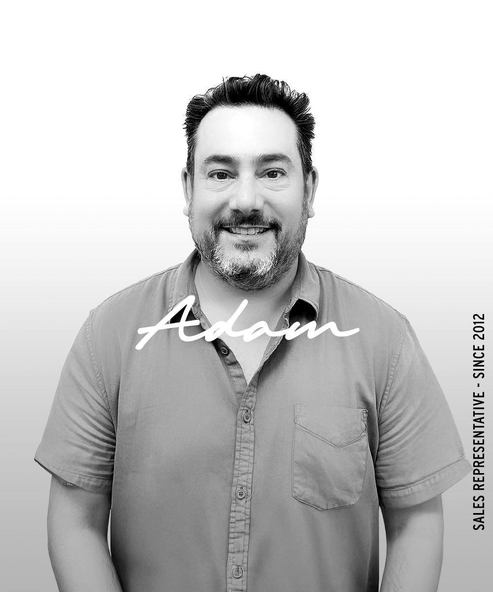 Black-and-white portrait of a man with the name “Adam” overlaid and vertical text reading “Sales Representative · Since 2012.”