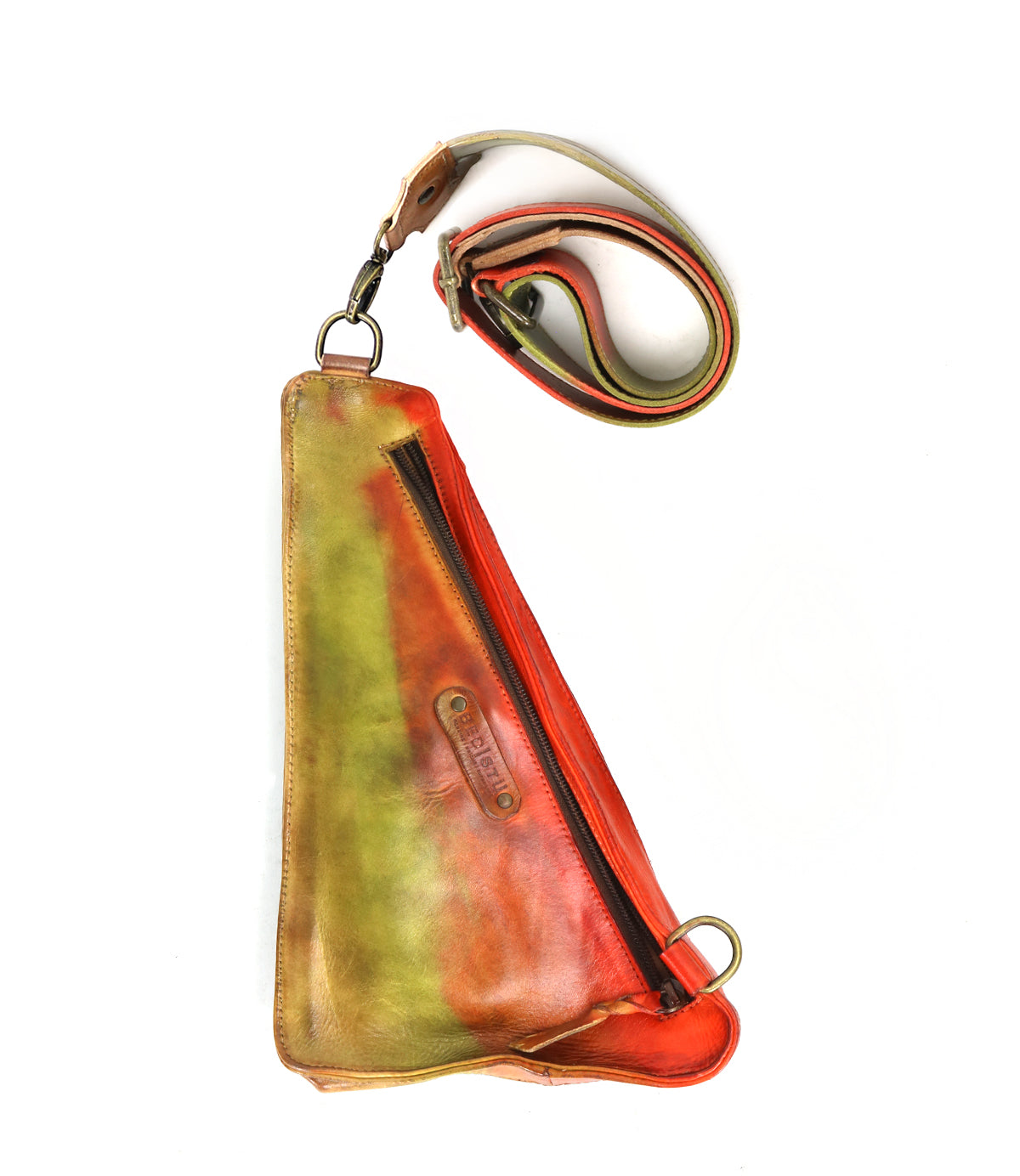 Introducing the Adept by Bed|Stü—a triangular compact sling crafted from vegetable-tanned leather, showcasing a diagonal zipper and a striking gradient of green, yellow, and red hues. The adjustable multicolored strap secures with sturdy metal rings, combining style and versatility in one elegant design.
