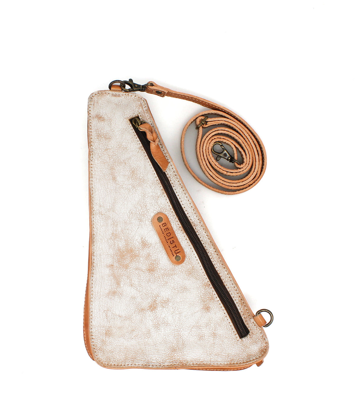 The "Adept" crossbody bag by Bed|Stü is a triangular beige accessory crafted from vegetable-tanned leather, featuring a front zipper pocket, brown trim, and an adjustable matching strap, displayed against a white background.