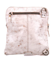 The Aiken by Bed|Stü is a square crossbody bag crafted from light beige full-grain leather, featuring visible stitching, metal hardware, and a front zipper pocket. Designed for versatility, it comes with an adjustable strap to ensure a comfortable fit.