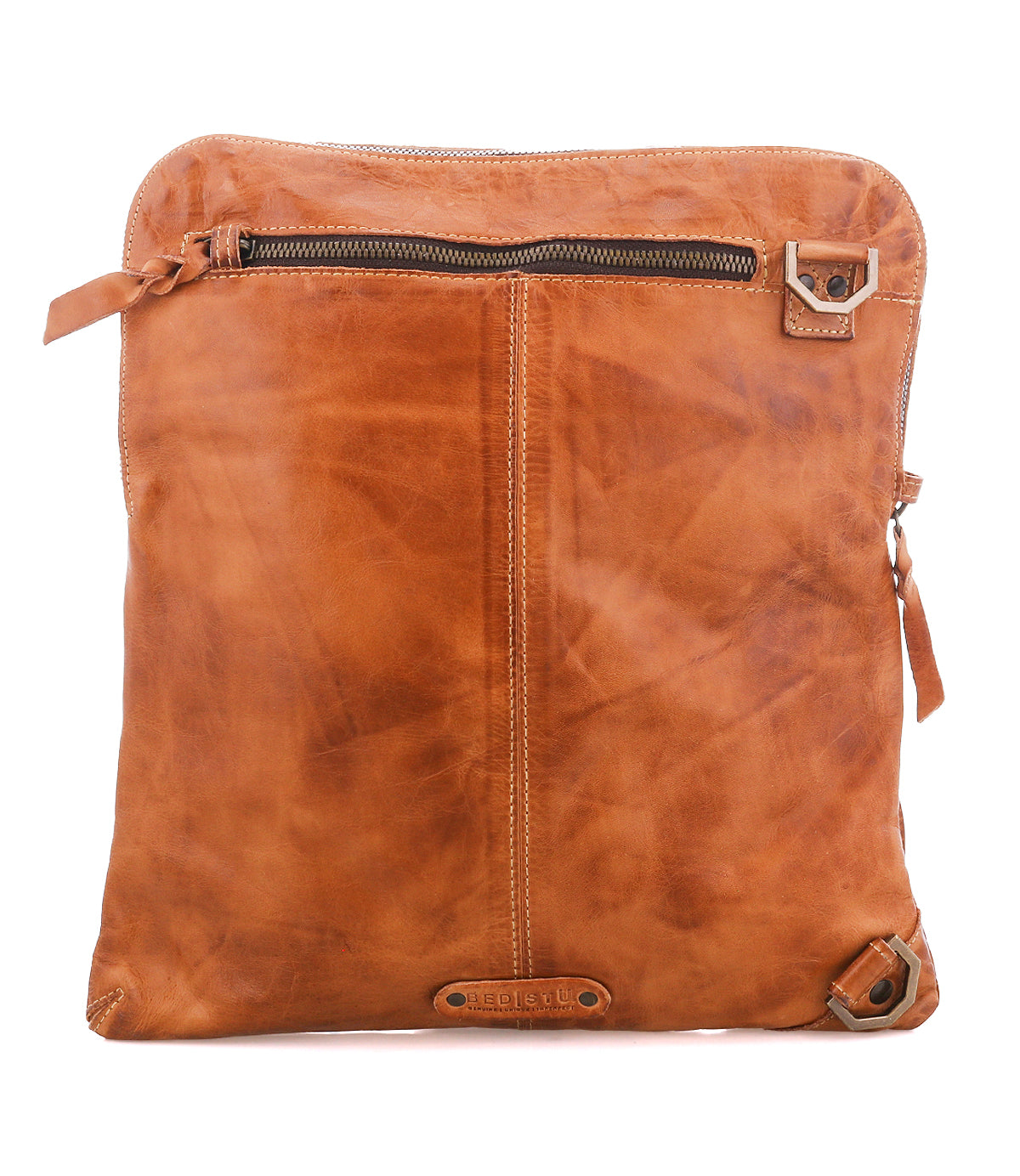 The Bed|Stü Aiken is a brown full-grain leather crossbody bag with a front zipper pocket, decorative stitching, and metal hardware on the corners. It features an adjustable strap for comfort and is photographed on a white background.