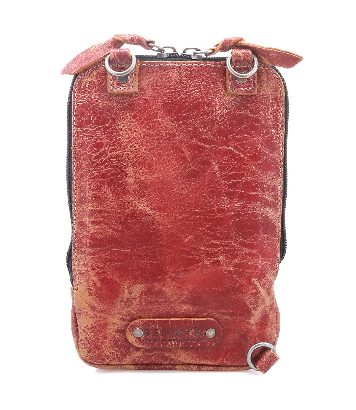 The Alelike by Bed|Stü is a small, rectangular crossbody bag crafted from red-brown leather, featuring a zipper closure, metal rings, and a textured, worn finish—perfect for carrying your travel essentials in a stylish and compact purse.