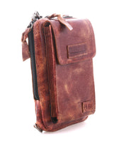 The Alelike by Bed|Stü is a small brown leather crossbody bag featuring a textured finish, front flap pocket, and secure zipper closure—ideal for organizing your travel essentials—shown here against a white background.