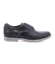 The Anchiano by Bed|Stü is a single black oxford shoe with laces, shown in a side view, showcasing visible stitching, a slightly worn sole, and crafted from distressed leather for added character.