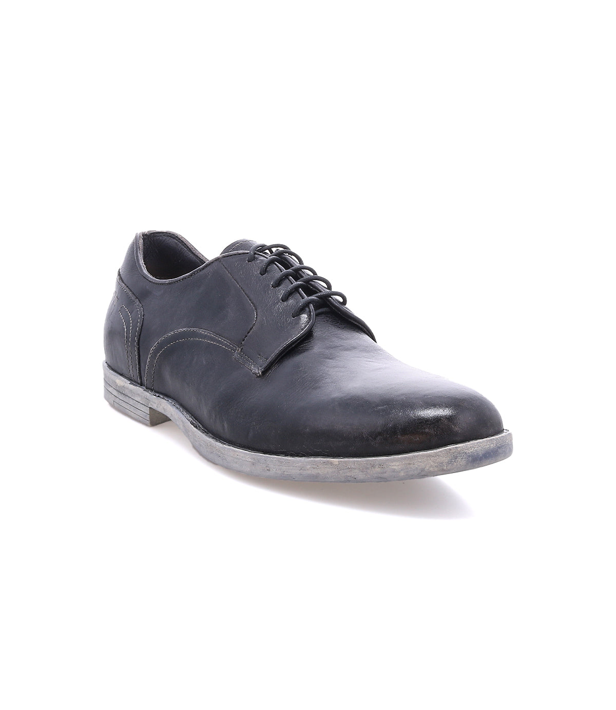The Bed|Stü Anchiano is a black leather lace-up oxford shoe featuring distressed leather and a slightly worn grey, flexible sole, photographed against a white background.