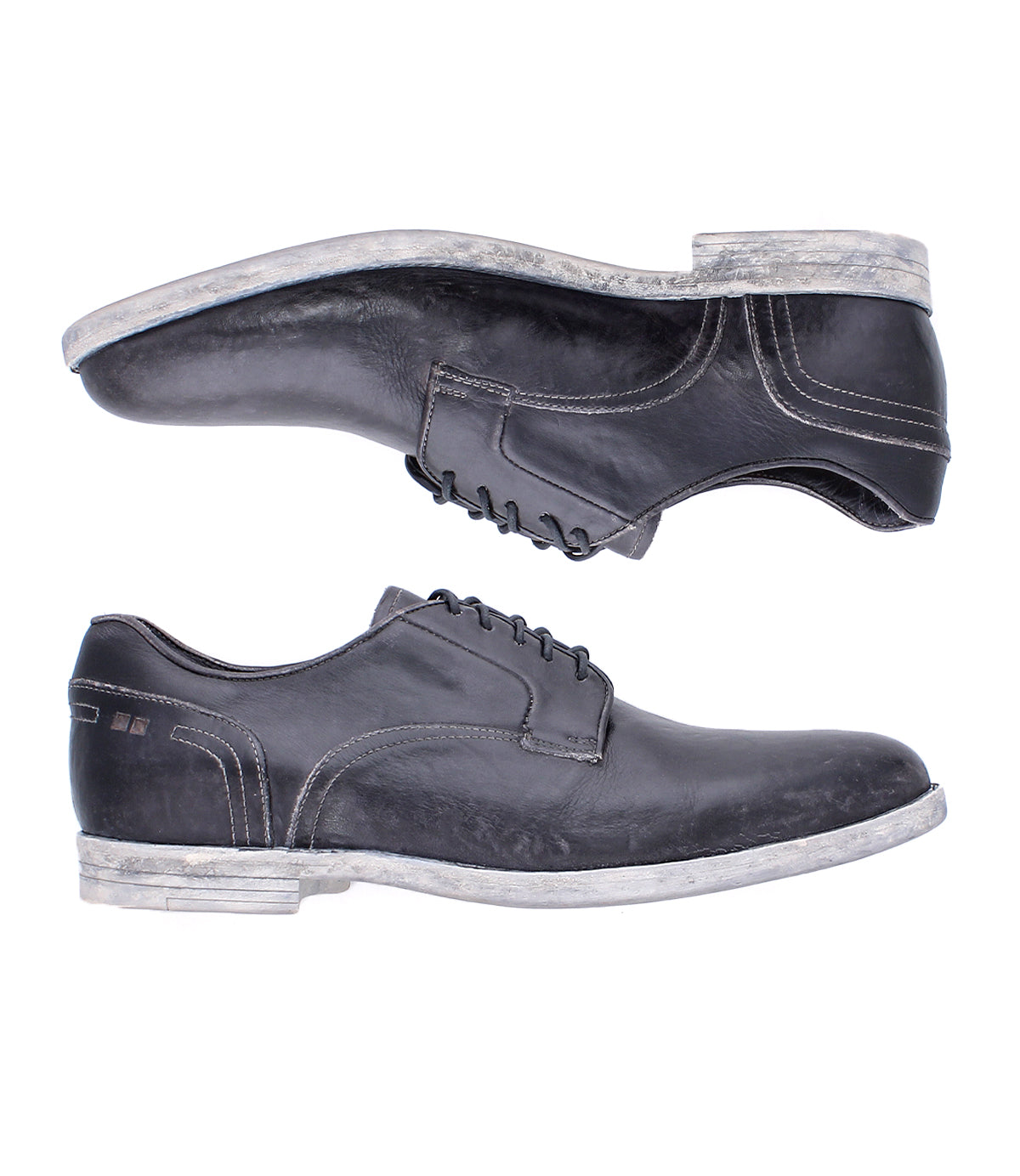 Two Bed|Stü Anchiano black oxford shoes with white stitching and worn, light-colored soles, crafted from distressed leather and displayed side by side on a white background.