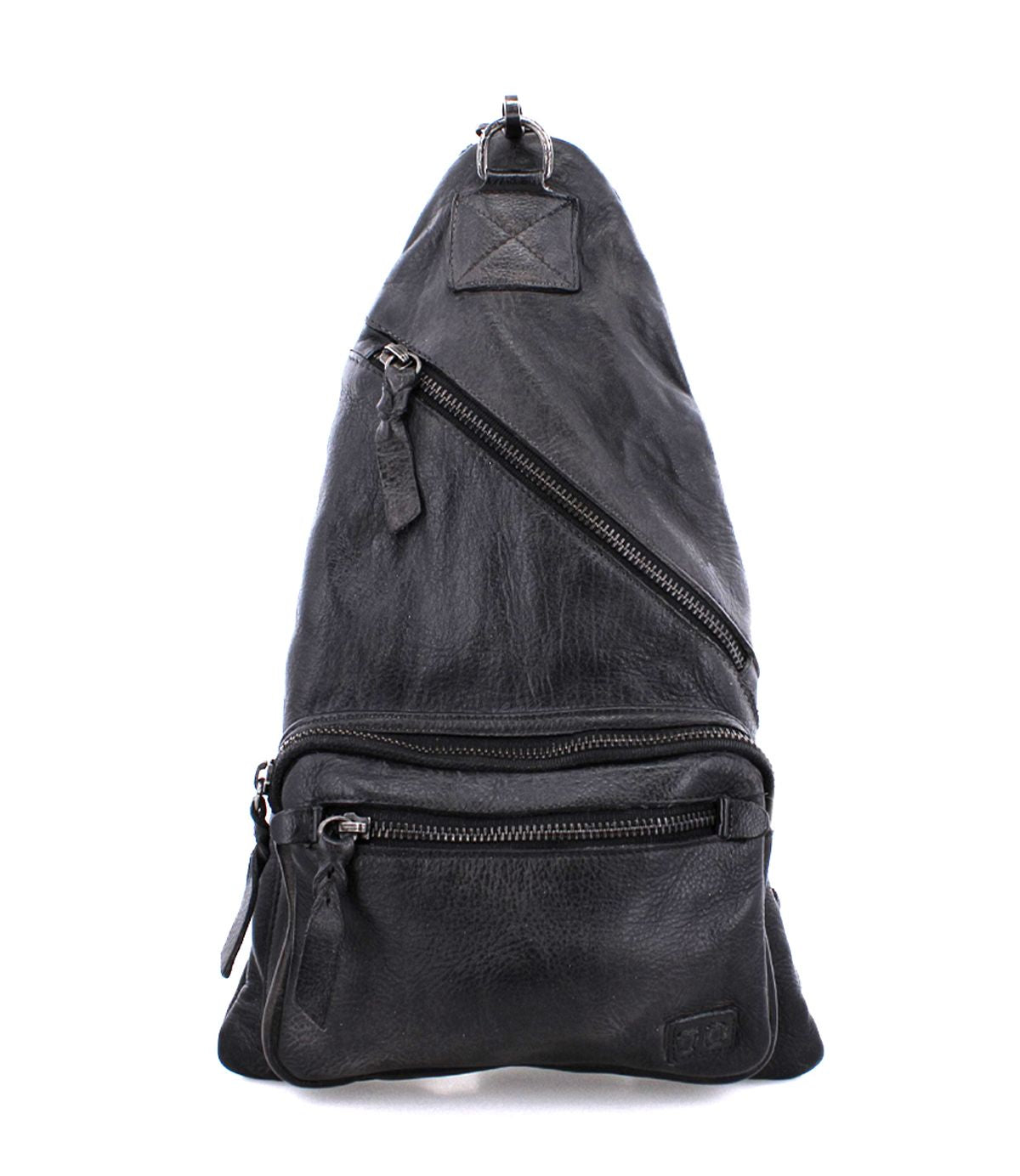 Bed|Stü's Andie black leather sling bag, featuring three zippered compartments and an adjustable strap, is pictured standing upright against a white background.