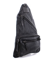 Bed|Stü Andie black leather sling bag with three zippered compartments and an adjustable strap, displayed upright on a white background.