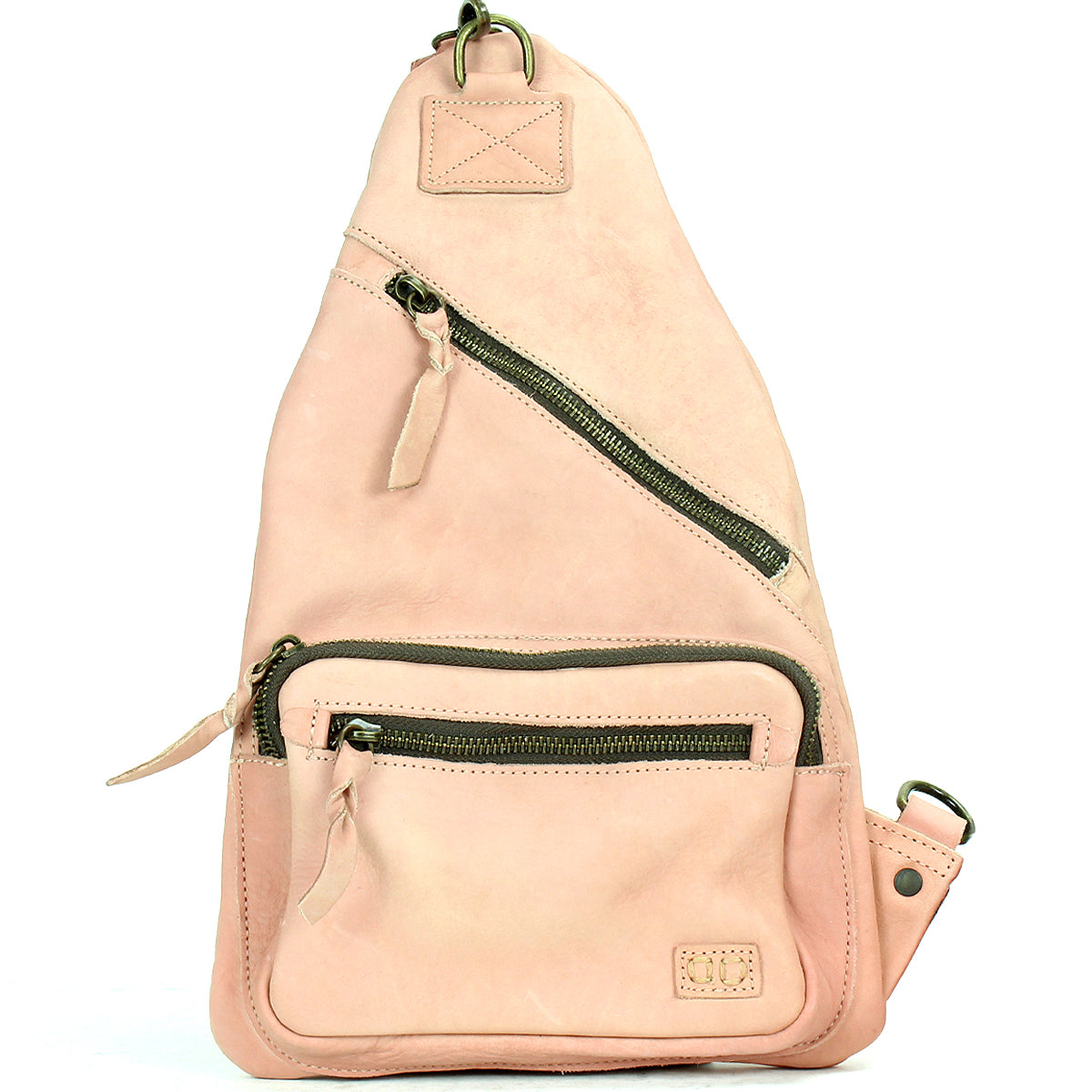 The Bed|Stü Andie is a light pink leather sling bag featuring two zippered compartments, a small front pocket, and an adjustable strap, displayed against a white background.