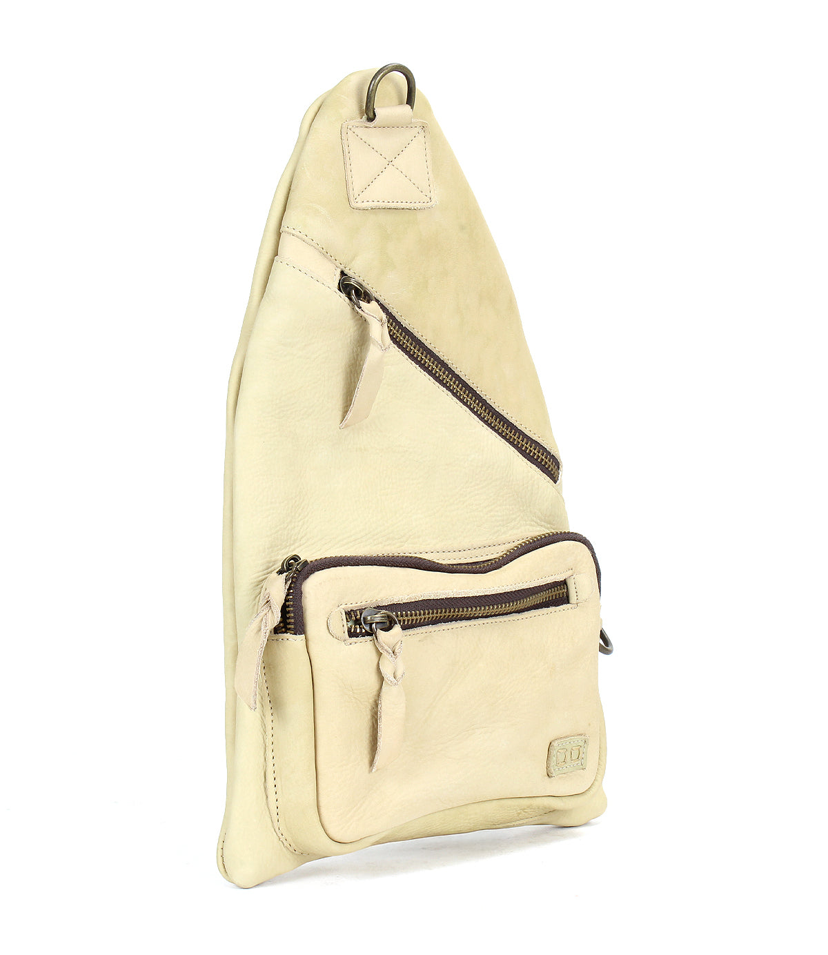 The Andie sling bag by Bed|Stü, crafted in beige leather, features two zippered compartments, an adjustable strap, and a front pocket, displayed upright against a white background.