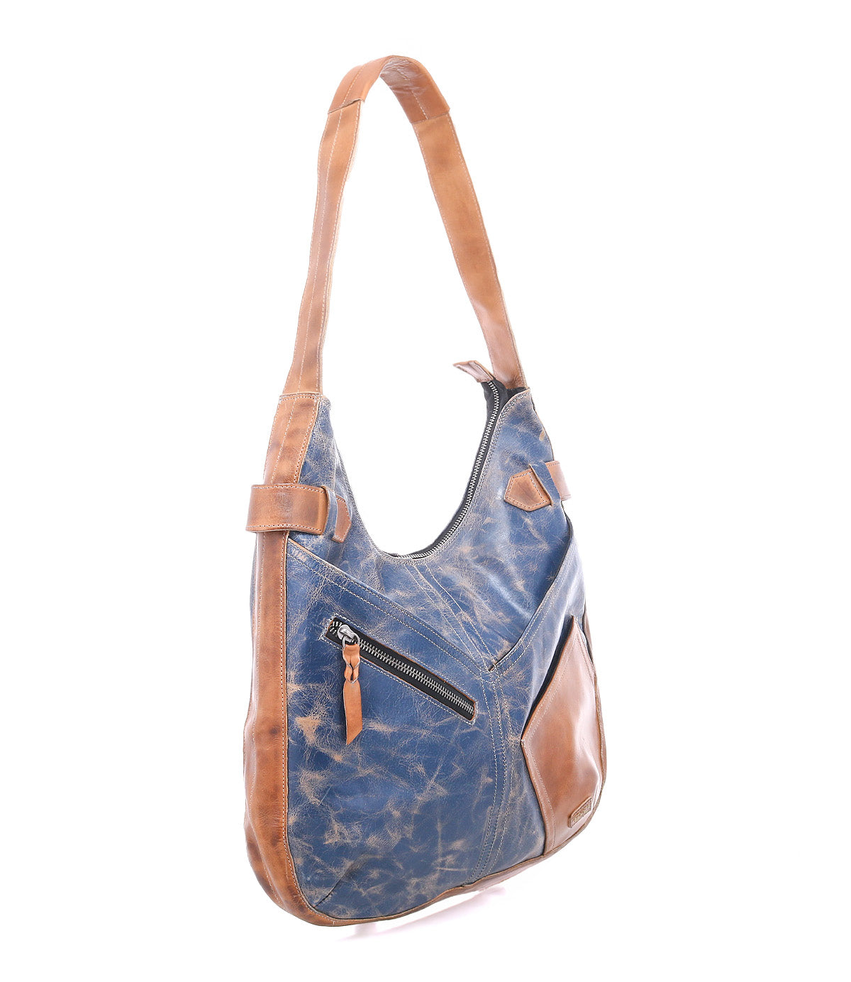 The Bed|Stü Argus is a blue and brown patchwork leather bag featuring a front zipper pocket, displayed against a white background.