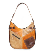 The Argus by Bed|Stü is a brown handcrafted leather shoulder bag with a patchwork design, featuring multiple shades, a zippered pocket, and oversized front pockets for added convenience.