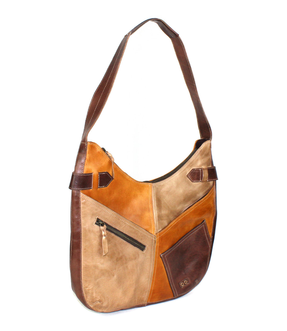 Introducing the Argus by Bed|Stü—a handcrafted leather shoulder bag showcasing brown and tan patchwork panels, an angled front zipper pocket, oversized front pockets, and a versatile adjustable strap.