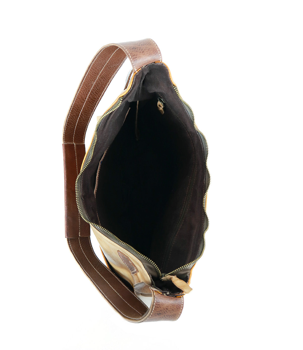 Top view of the Bed|Stü Argus, a handcrafted brown leather shoulder bag featuring a wide strap, gold zipper, and spacious dark interior with a zippered inner pocket. This stylish patchwork leather bag blends elegance and functionality for everyday use.