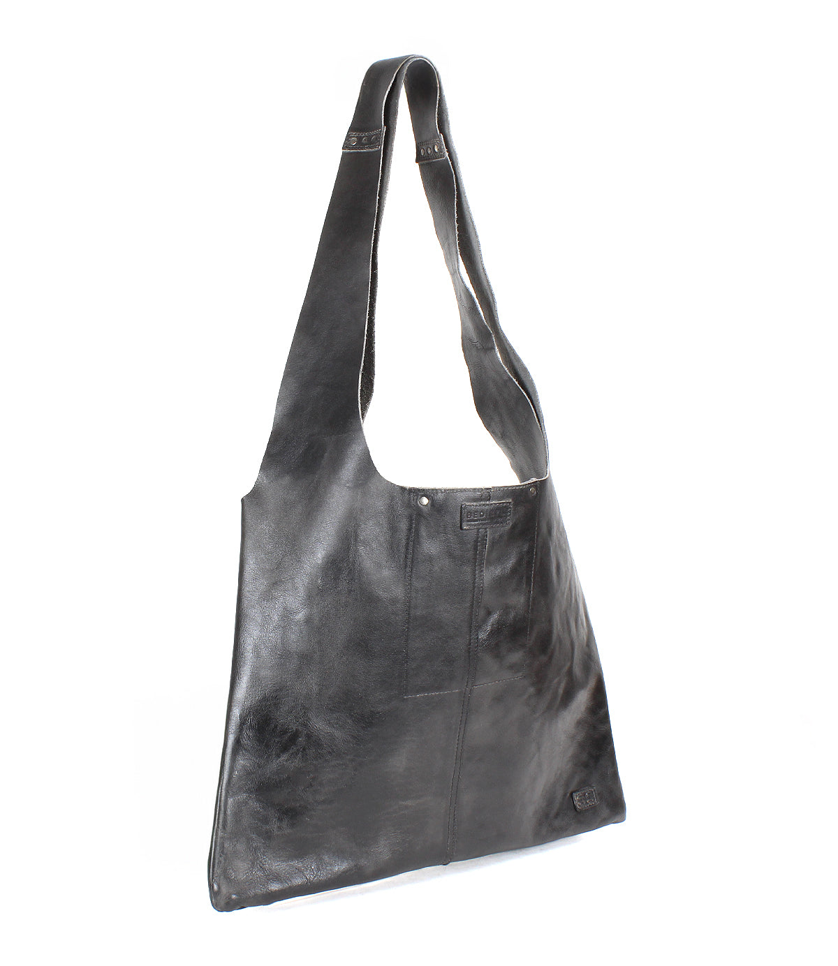 The Bed|Stü Ariel II tote bag features black leather, a wide strap, rectangular silhouette, and visible stitching, photographed against a white background. This spacious tote is both stylish and practical for everyday use.