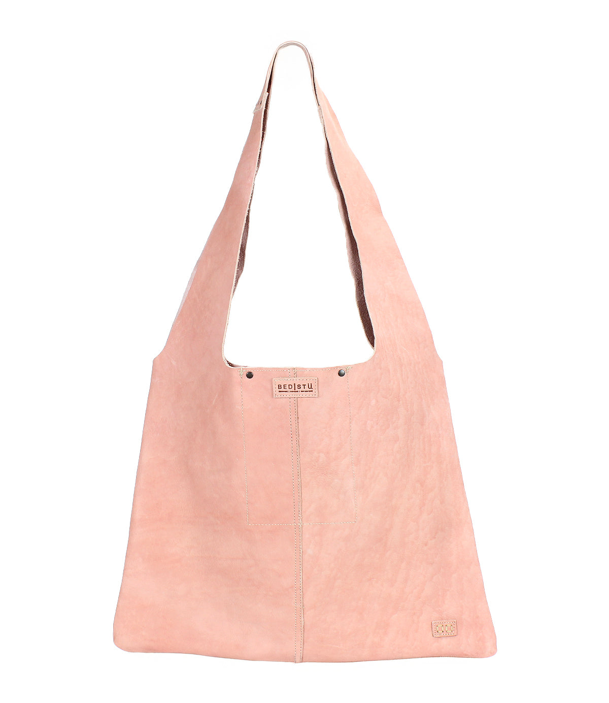 The Ariel II by Bed|Stü is a light pink suede spacious tote bag featuring a wide strap, visible center stitching, and a small rectangular Bed|Stü brand tag near the bottom right corner.