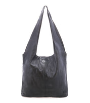 The Ariel Max by Bed|Stü is a large black hand-finished leather shoulder bag featuring a wide strap, a rectangular body, and minimal stitching details. Designed with a spacious interior, it is photographed against a plain white background.