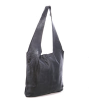 The Ariel Max by Bed|Stü is an oversized black leather shoulder bag with a rectangular silhouette and a long, wide strap. Hand-finished for a unique look, this spacious tote is perfect for carrying all your essentials in style and is photographed against a white background.