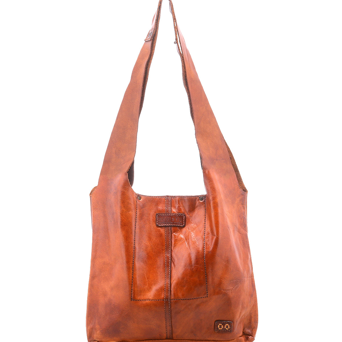 The Ariel Mid by Bed|Stü is an artisanal brown shoulder bag crafted from vegetable-tanned leather, featuring a wide strap, front stitching details, and a small rectangular patch near the bottom corner, displayed on a white background.