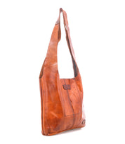 The Bed|Stü Ariel Mid is a brown full-grain leather shoulder bag featuring a wide strap, visible seams, and a rectangular shape, photographed against a white background.