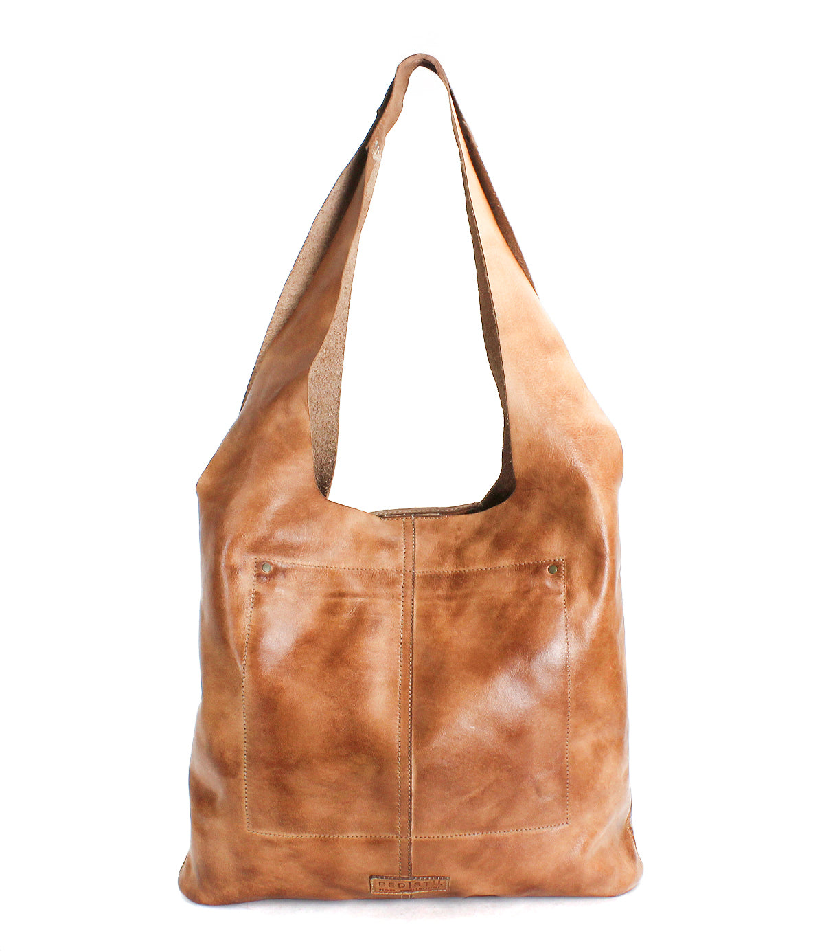 The Ariel EM by Bed|Stü is a light brown minimalist tote bag featuring a wide shoulder strap and two front pockets, displayed standing upright against a white background.