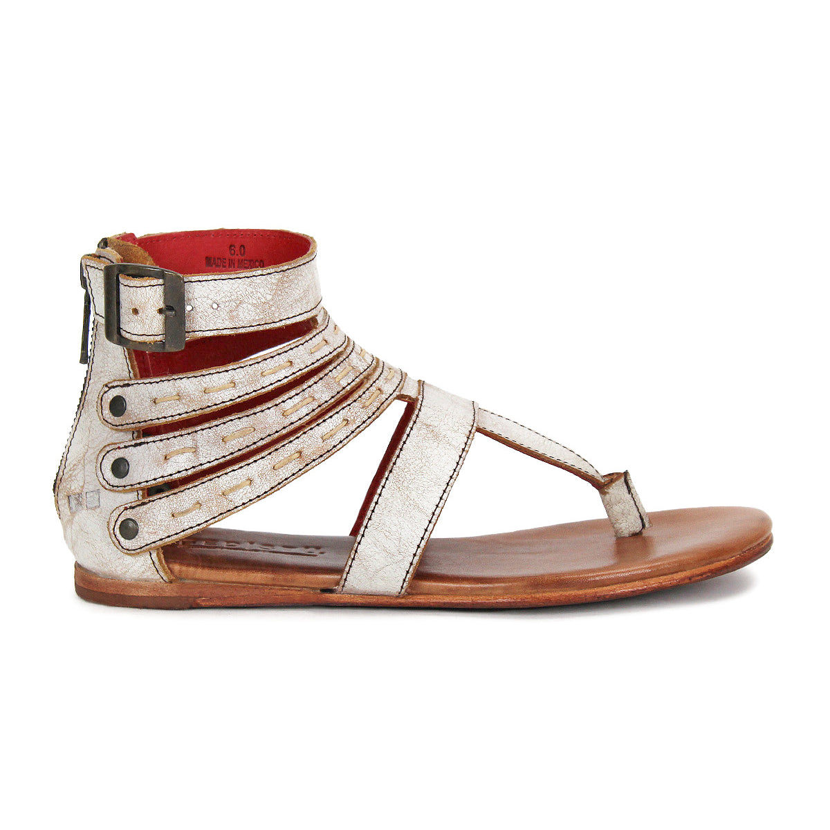 The Artemis II by Bed|Stü is a metallic silver gladiator sandal with multiple leather straps, a buckle closure, toe loop, and a flat brown sole, displayed in side profile.