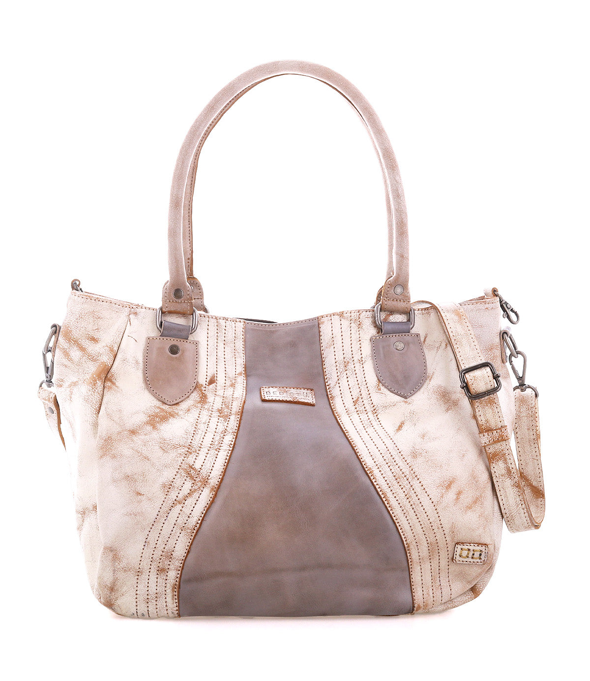 The Bed|Stü Astana is a large tan and brown leather handbag with dual handles, decorative stitching, metal accents, and a detachable shoulder strap, shown against a white background. This modern accessory blends timeless style with practical features, making it the ideal everyday bag.