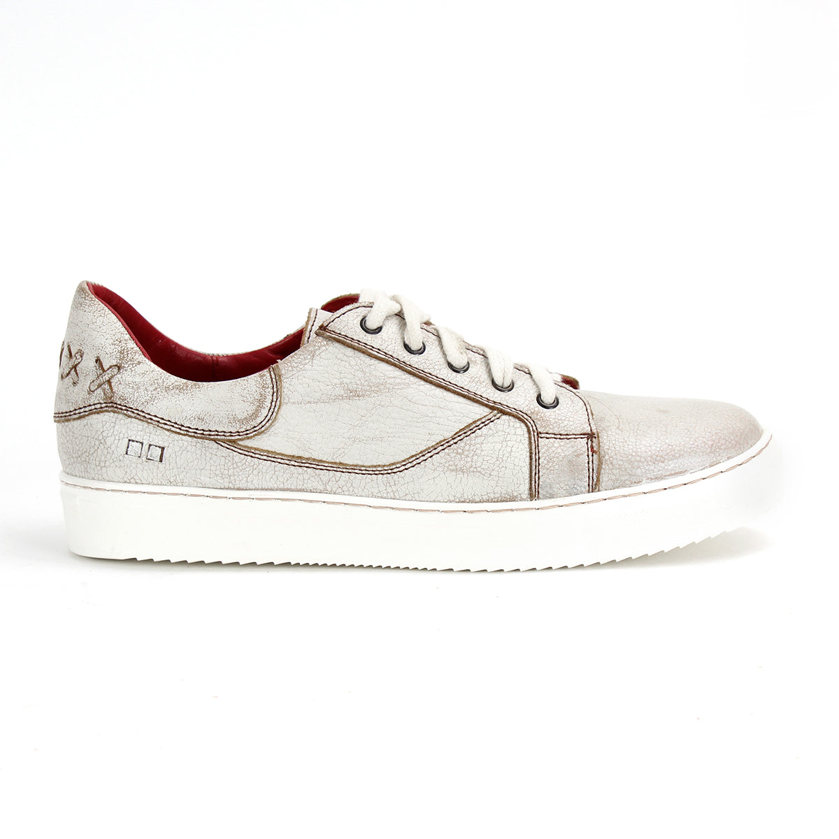 The Bed|Stü Azeli is a white leather sneaker featuring brown stitching, white laces, and a red interior, presented in a side profile view against a plain white background. Designed for all-day comfort, this casual shoe is also equipped with a durable rubber outsole.