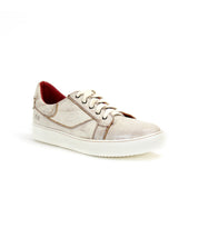 The Azeli sneaker by Bed|Stü is a beige leather shoe featuring a white, durable rubber outsole and a red inner lining, crafted for all-day comfort. Displayed against a plain white background.
