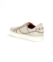 Azeli by Bed|Stü is a light-colored leather sneaker shown from the rear, featuring white laces, a textured finish, and three stitched "X" details on the heel. Designed for all-day comfort, it includes a durable rubber outsole.