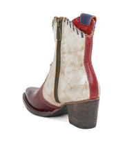 Introducing the Baila II by Bed|Stü—a Western-inspired ankle boot featuring a pointed toe, convenient side zipper, bold red and white panels with blue stitching, and artisanal craftsmanship atop a stacked wooden heel.