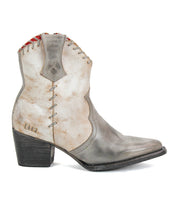 A single Baila II boot by Bed|Stü in light gray leather, featuring artisanal construction, decorative stitching, a pointed toe, and a slightly angled heel, is shown in profile against a white background.