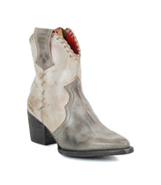 The Baila II by Bed|Stü is a single distressed gray leather ankle boot featuring artisanal construction, a pointed toe, decorative stitching, a red inner lining, and a chunky stacked heel—effortlessly blending Western-inspired rugged charm with sophisticated detail.