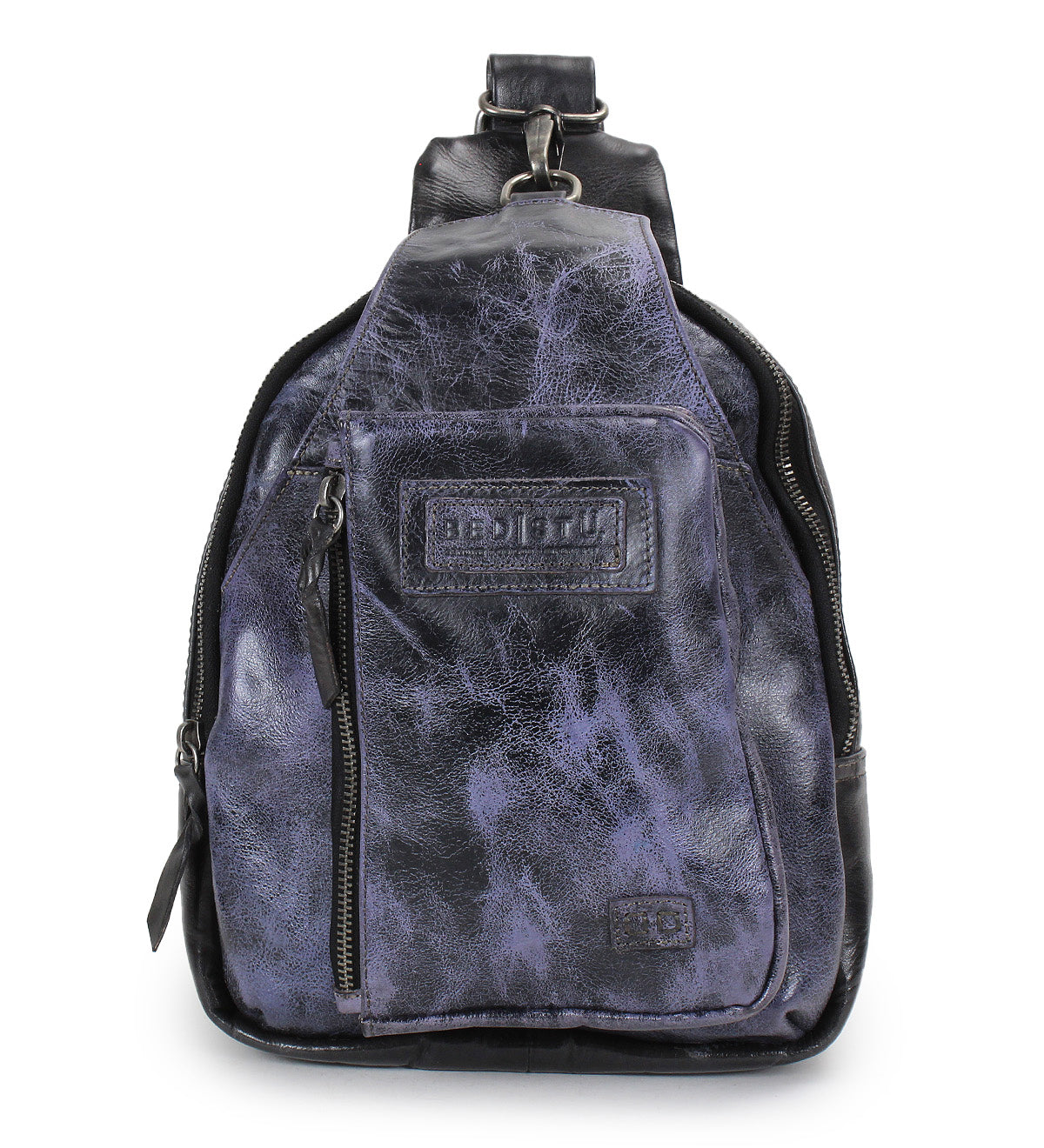 A small Beau sling backpack by Bed|Stü in dark purple and black leather, featuring a front zipper pocket and a stitched Bed|Stü brand label on the front.