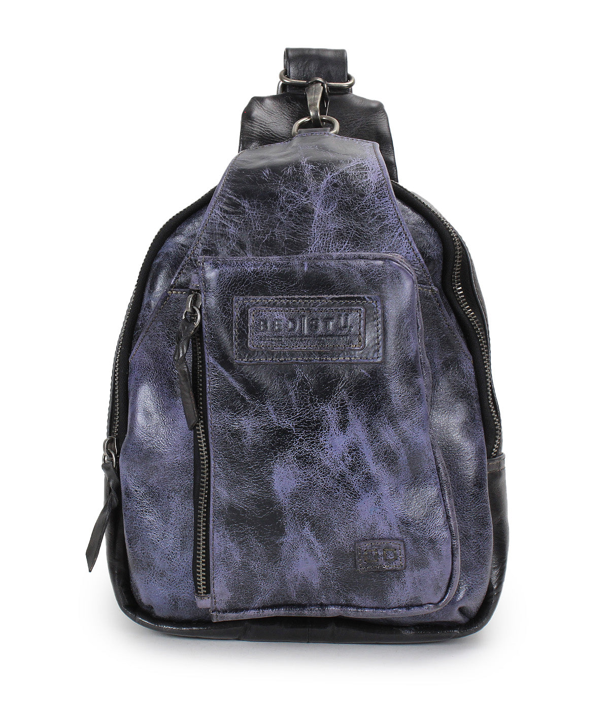 A small Beau sling backpack by Bed|Stü in dark purple and black leather, featuring a front zipper pocket and a stitched Bed|Stü brand label on the front.