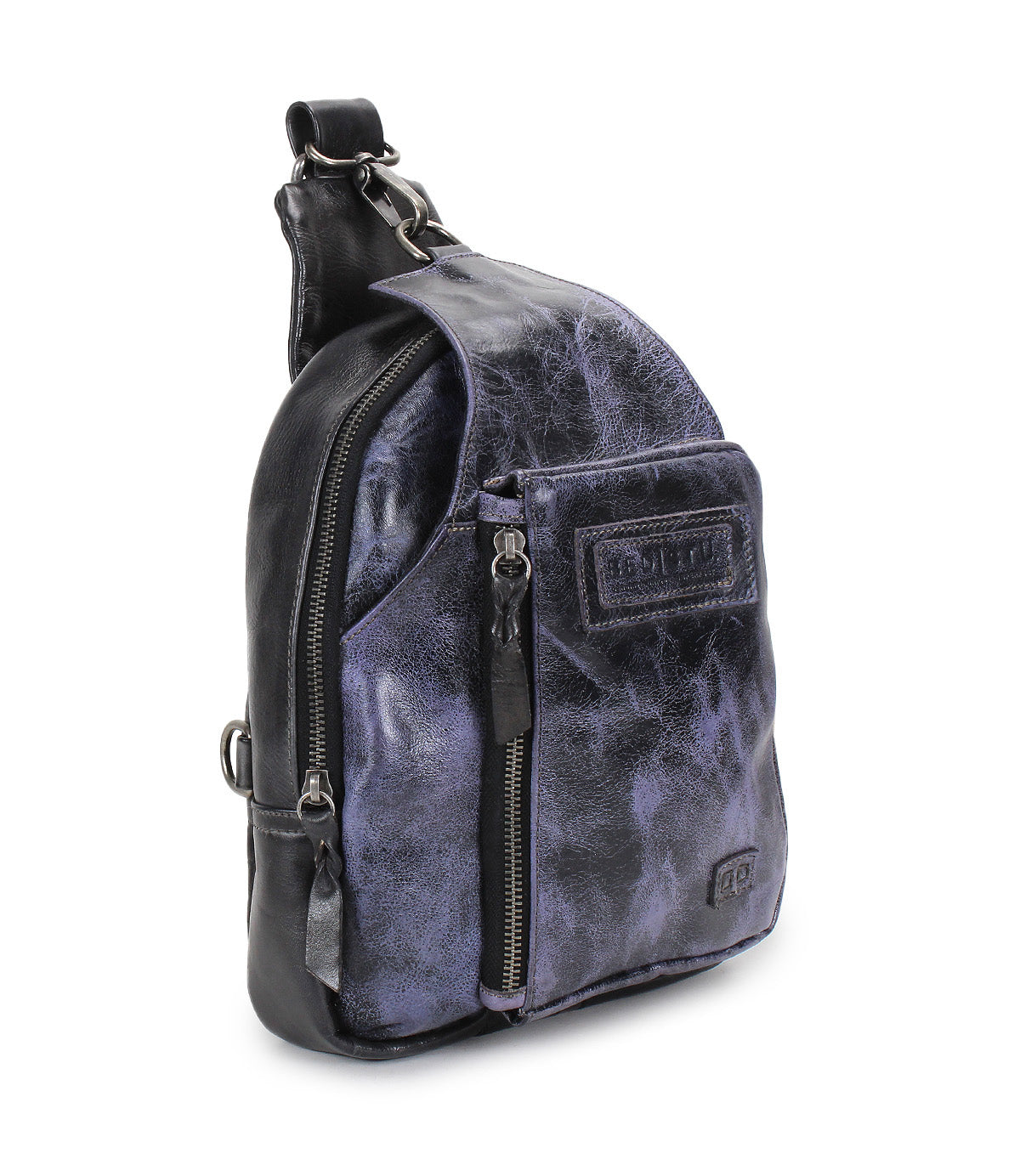 Introducing the Beau sling backpack by Bed|Stü—a compact leather bag featuring a striking purple and black marbled finish, front zipper pocket, and top handle. This stylish design is perfect for those wanting a functional backpack that doesn’t compromise on flair.