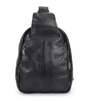 The Bed|Stü Beau is a black leather sling backpack featuring a single wide strap, displayed front-facing against a white background; this compact design combines style and everyday functionality.