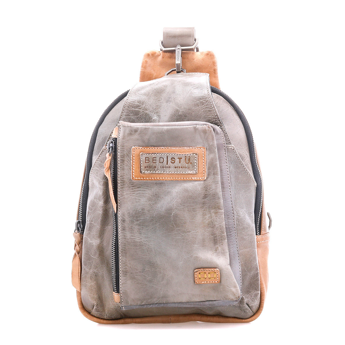 The Beau backpack by Bed|Stü is a small sling bag in gray and brown leather, featuring a front zip pocket, a top handle, and the brand's signature label, shown against a white background.