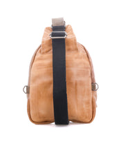 Beau by Bed|Stü—a tan leather sling bag featuring a wide black adjustable strap, displayed from the back against a white background—offers a stylish and compact alternative to a traditional backpack for carrying everyday essentials.