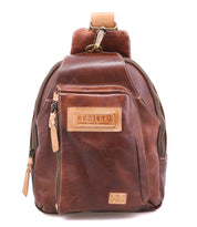A small brown leather sling backpack called the "Beau" by Bed|Stü, featuring a front zipper pocket, tan leather zipper pulls, and a stitched "BED|STU" label on the front.